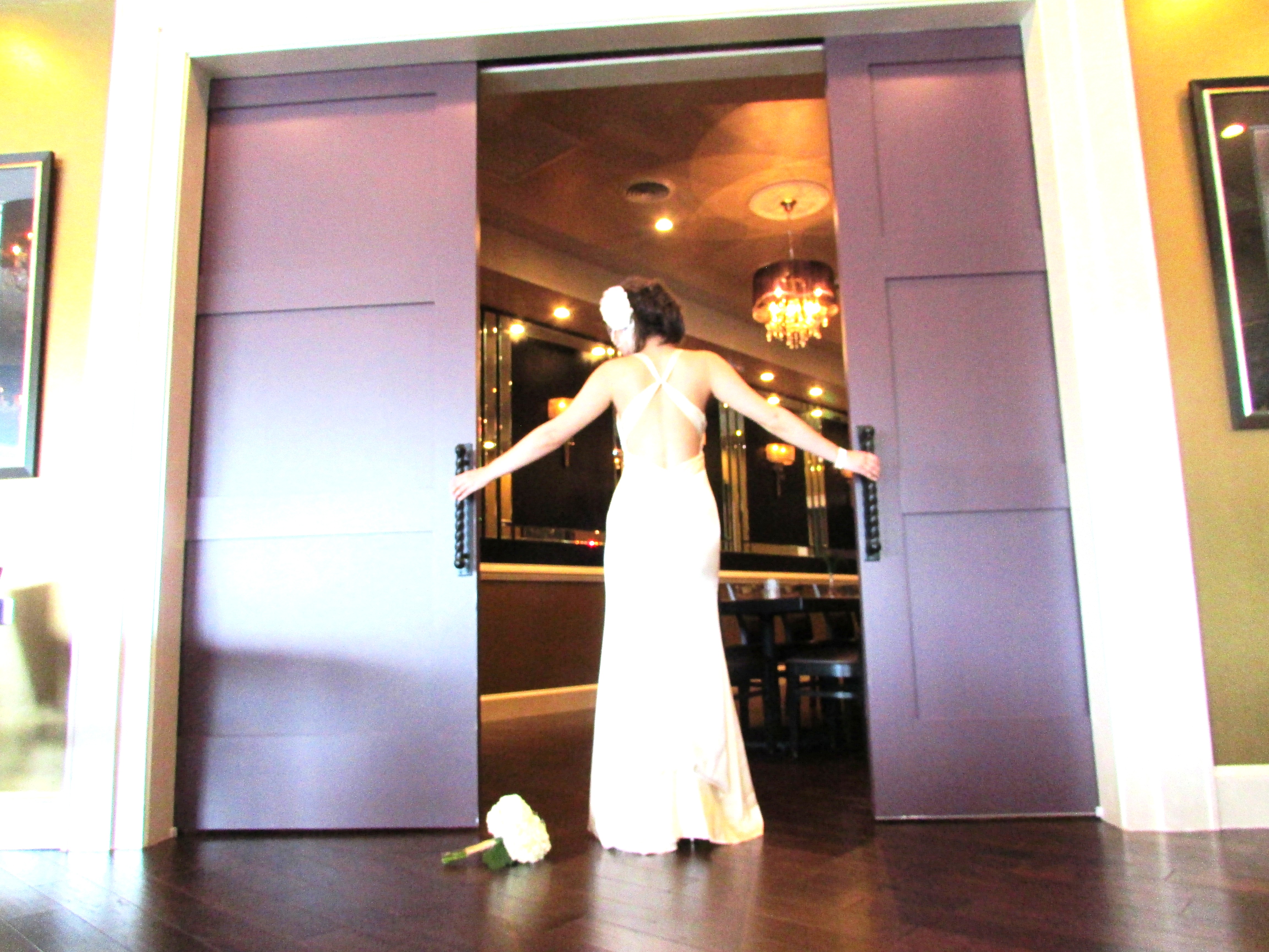 Bride wearing white standing in the doors of the Chaplain Room.
