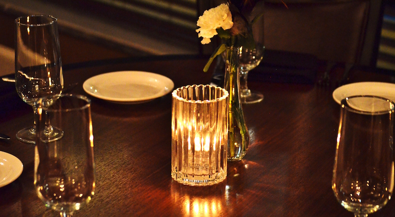Showing a table centerpiece illuminated by candlelight.