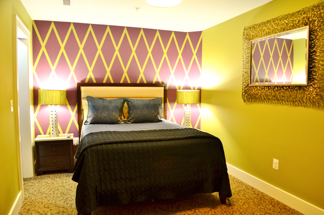 This is a photo showing the bedroom of the Luxury Suite with Kitchenette at the Culpeper Center.